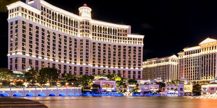 Bellagio Hotel and Casino with Bellagio Fountain light show and Caesars Palace at night