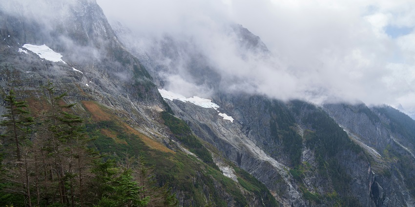 An image of the park, featuring lush forests, rugged mountains, and a serene lake.