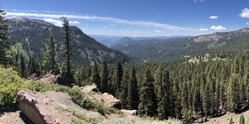 A view of the park with majestic peaks, bubbling hot springs, and stunning vistas.