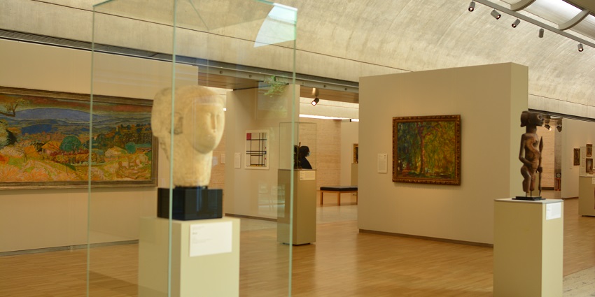 An image of a close-up of a sculpture and a painting on display in the Kimbell Museum