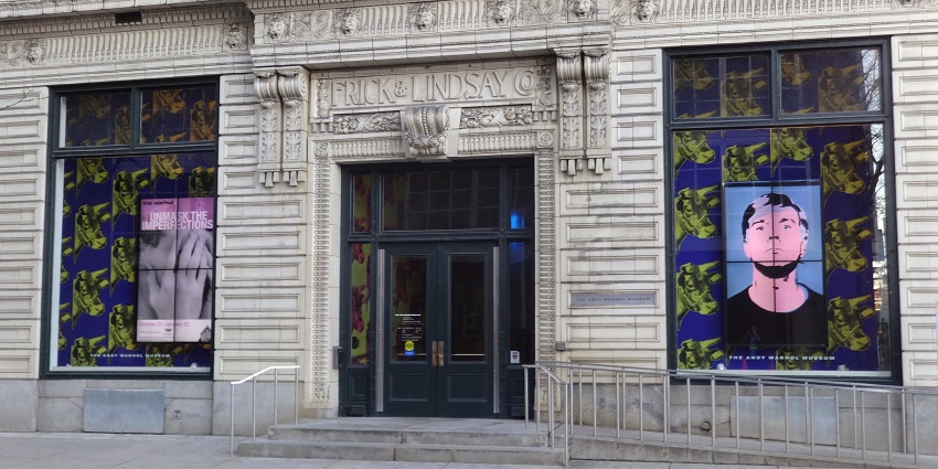 An Image of The Andy Warhol Museum in Pittsburgh, displaying vibrant murals on its exterior walls.