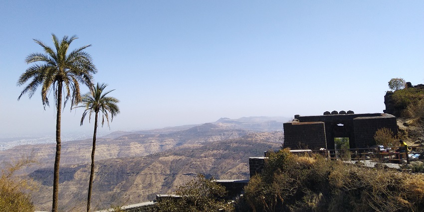 A picture of Barud Khana from Sinhgad fort with clouds and a clear sky in the background