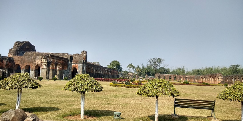 A picture of Adina Mosque, a large brick mosque with intricate carvings