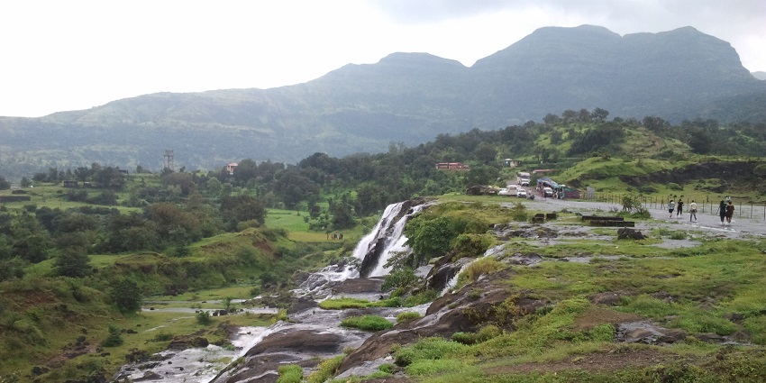 An image view of Wilson Dam and lush greenery in Bhandardara during monsoon season.