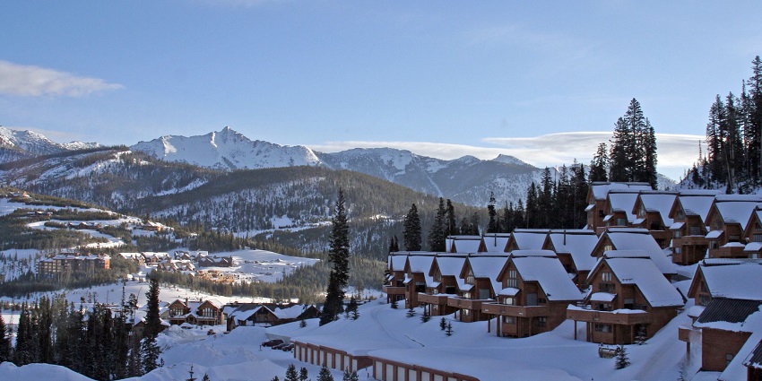 A view of Big Sky Resort with pine trees, a famous place near the USA's Yellowstone National Park.

