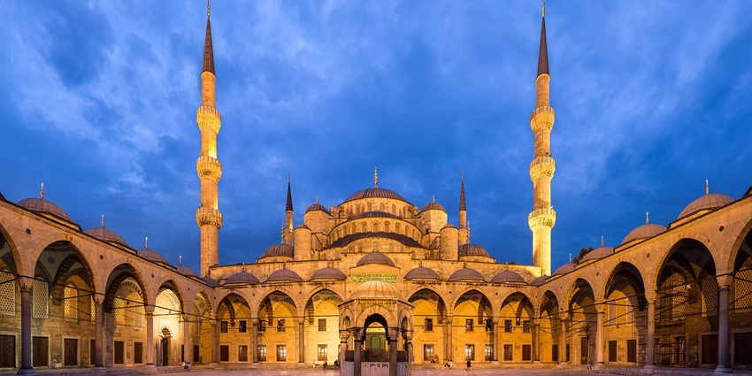 Magnificent mosque with grand domes, minarets, and intricate tiles.