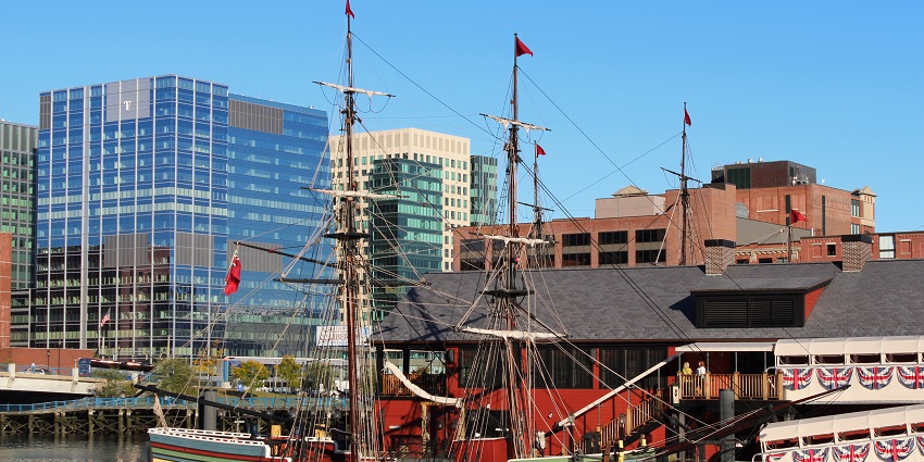 The ship model of Boston Tea Party in the harbour with buildings in background