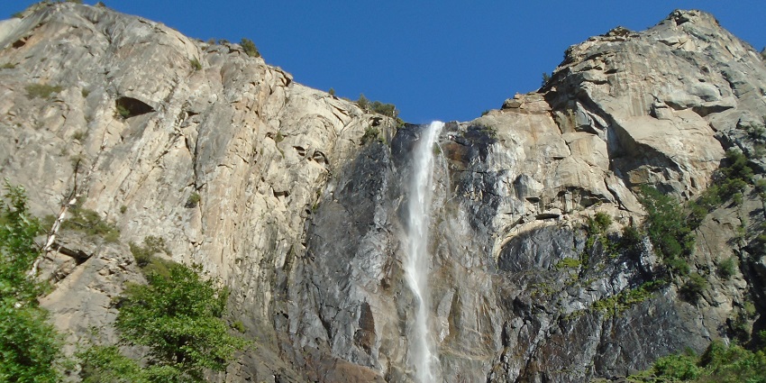 Dry Bridalveil Fall at sunset in Yosemite National Park, showcasing its majestic cliffside.