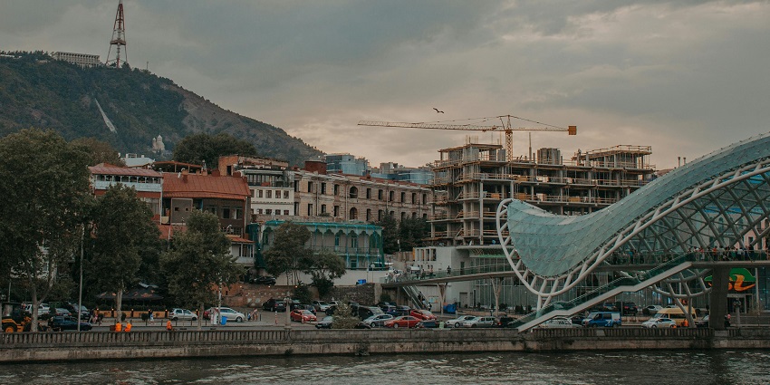 Places to visit in Tbilisi include a modern pedestrian bridge offering scenic views.