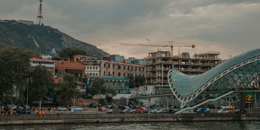 Things to do in Tbilisi include a modern pedestrian bridge offering scenic views of Tbilisi city.