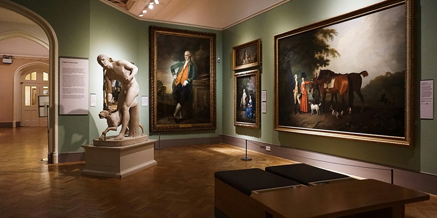 Art gallery interior with framed paintings hanging on walls, featuring colourful modern artwork, one of the best things to do in Park Street Kolkata.