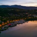 Pancherevo Lake from the top with lit roads, buildings, boats and yachts parked