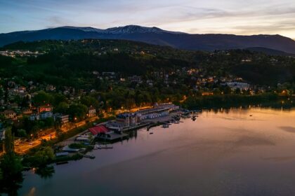 Pancherevo Lake from the top with lit roads, buildings, boats and yachts parked