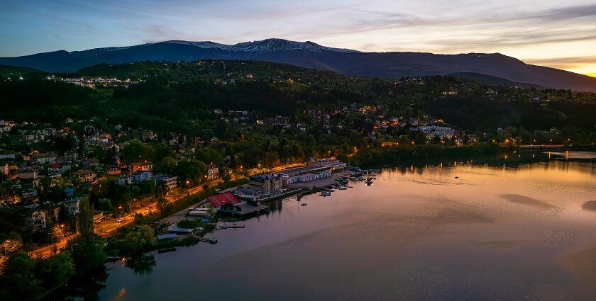 Pancherevo Lake from the top with lit roads, buildings, boats and yachts parked