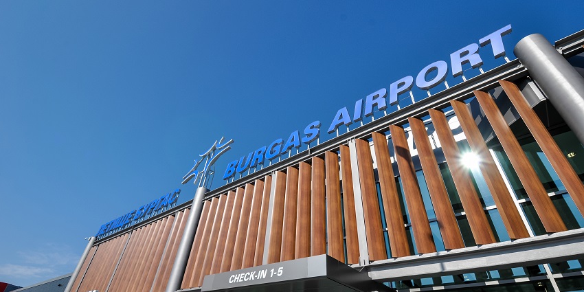 Burgas airport building with unique architecture, multiple signage and a clear blue sky
