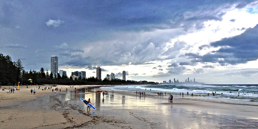 People enjoying different water activities at Burleigh Heads Beach in Queensland.