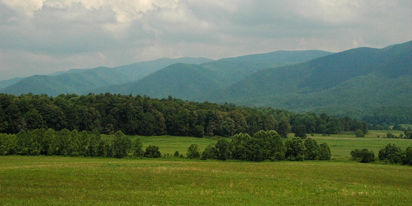 View of Cades Cove, a famous place near Great Smoky Mountain National Park, with open fields