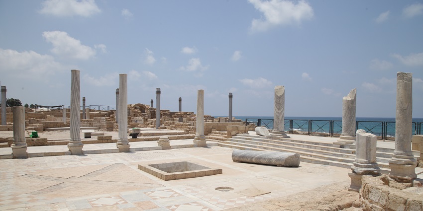 Ancient Roman city with ruins, a theater, and a stunning coastline