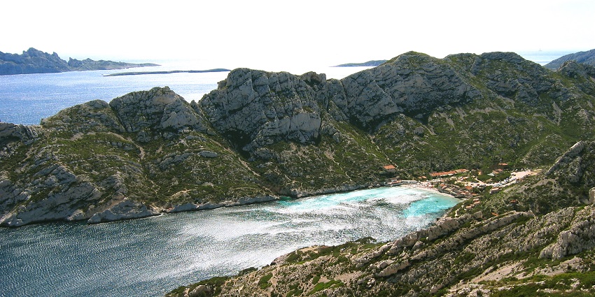 Beaches in Marseille with turquoise water and dramatic limestone cliffs.