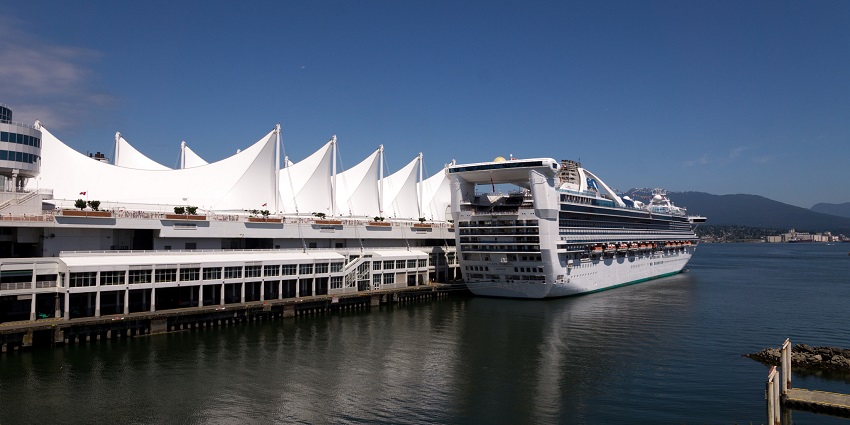 A picturesque view of Canada Place, and on the harbour there is a luxury cruise ship