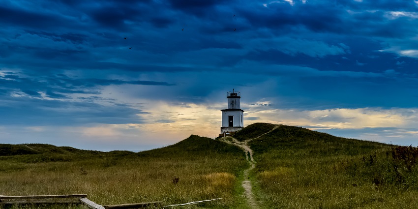 The enchanting lighthouse near Coolangatta Beach illuminates in the night.