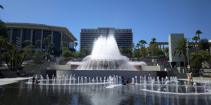 People enjoy near one of the fountains at the Grand Park in Los Angeles, California.