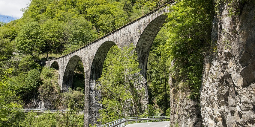 An image of a majestic bridge spanning a scenic valley with breathtaking mountain views.