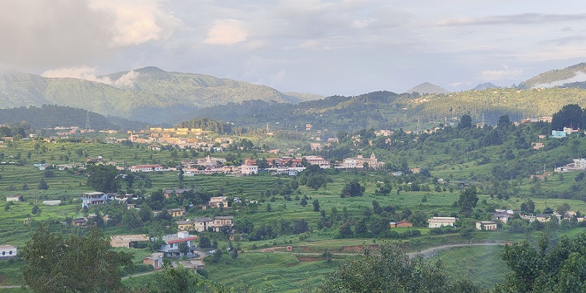 A picture of Champawat with hills and the Shani Temple in the foreground.