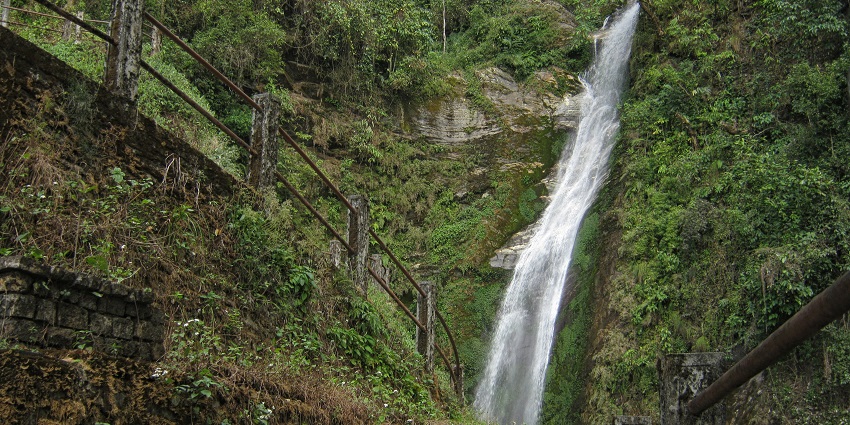 A picture of Changey Waterfalls in Kalimpong as tall surrounded by dense greenery