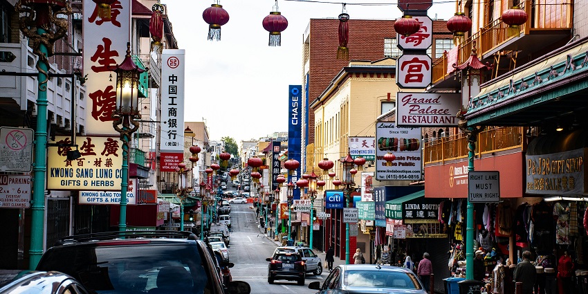 Numerous Chinese lamps, which are red and golden, are hanging for a celebration.