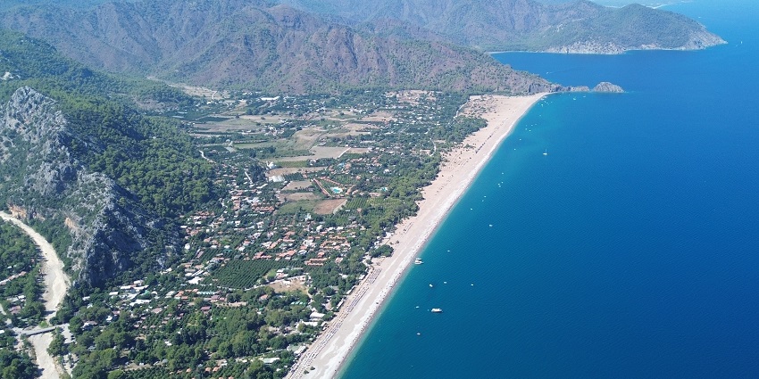 Peaceful beach with ancient ruins and protected sea turtle habitat.