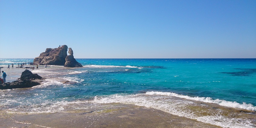 Famous sandy beach with crystal-clear waters and ancient ruins.
