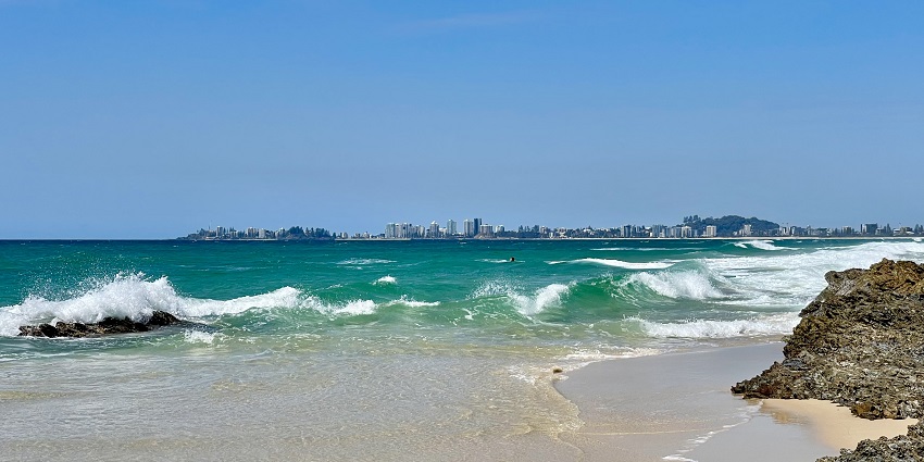 Witness soft sand, clear water, and consistent surf breaks at Coolangatta Beach.