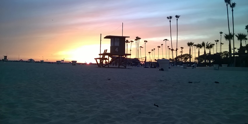 An image of a sunset view of Corona Del Mar Beach, a famous beach in Orange County.