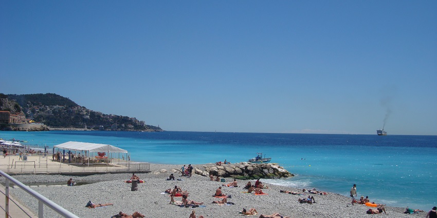 Relax on Croûton Beach's pebbly shores, Nice's scenic gem