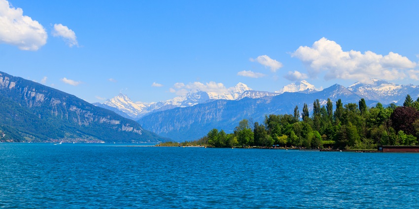 Things to see in Interlaken in June include a lake cruise with picturesque Swiss landscapes and turquoise waters
