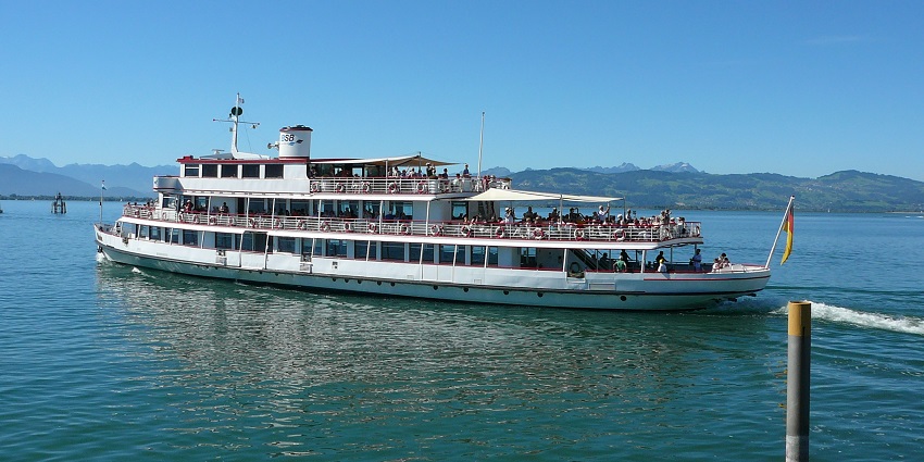 Scenic boat cruise across the picturesque Lake Thun under clear blue sky