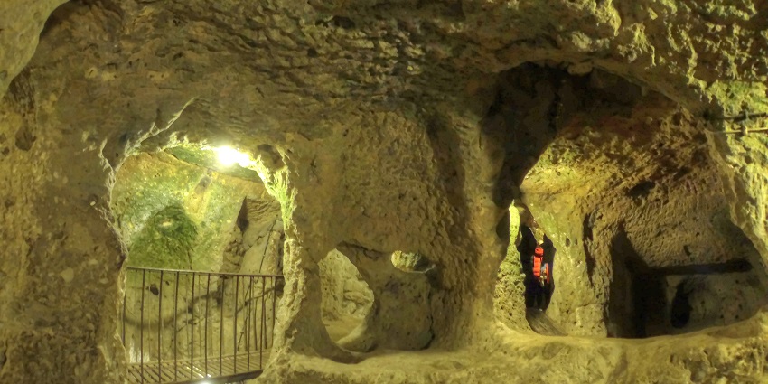 Ancient subterranean city with tunnels, rooms, and historical significance.