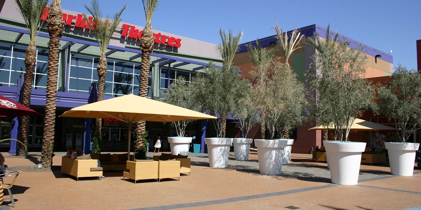 A Free Taste sign at a marketplace is a popular destination near the musical instrument museum.