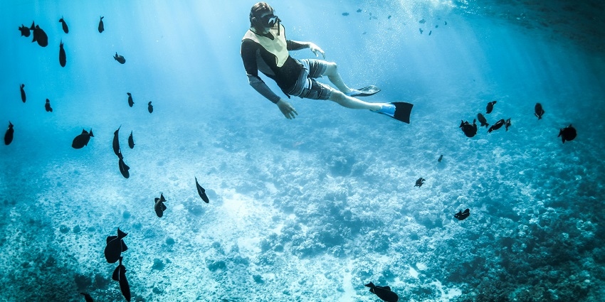 An image of Devbag Beach with gentle waves, which is safe for scuba diving.
