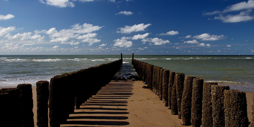 Scenic beach view with clear waters, ideal for relaxation and activities.