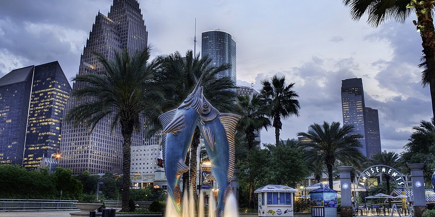 A picture of a fountain with two dolphin statues at an aquarium in Houston