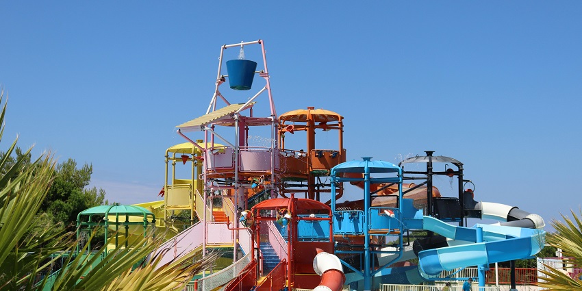 An image of Dream World Water Park with visitors enjoying indoor water rides and attractions.