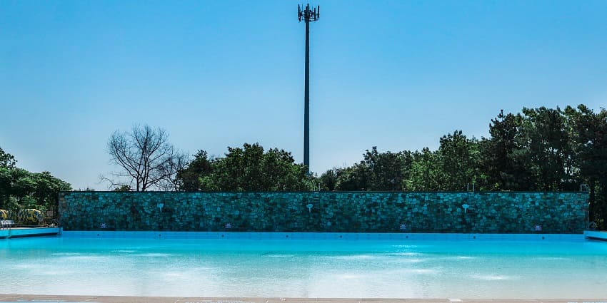 A view of two boys joyfully playing in a swimming pool on a bright water safari in NYC.