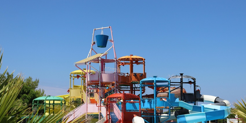 An image of Blue World Theme Park in Kanpur full of slides, water and palms