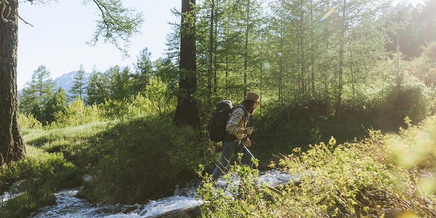 A man trekking along the river perfect for nature lovers surrounding Kankalitala Temple.