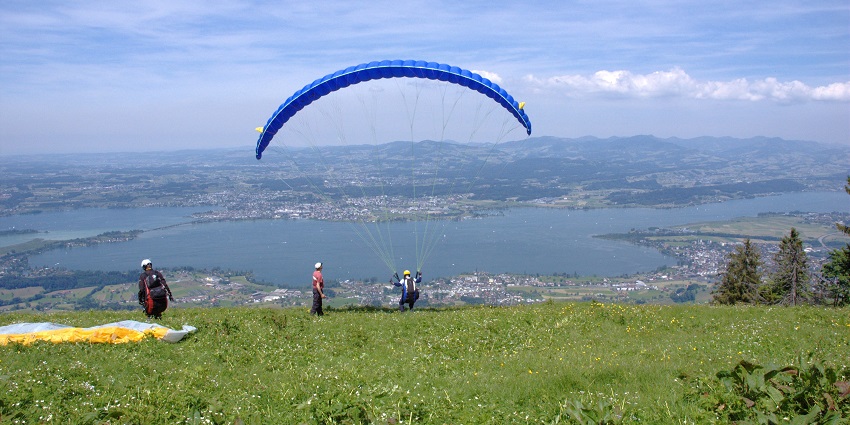 Things to do in Interlaken in June include paragliding with panoramic views of Swiss mountains