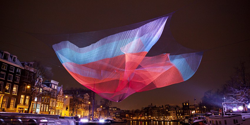 Stunning light installations illuminating the canals and cityscapes at night.