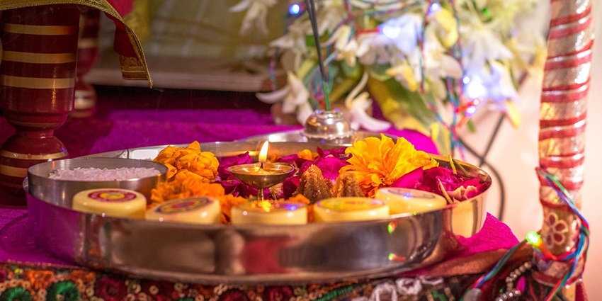 Image of a aarti thali decorated with flowers and incesne sticks and other hindu ritual essentials