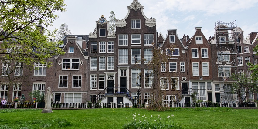 Explore the historic peaceful courtyard with ancient buildings and lush greenery.